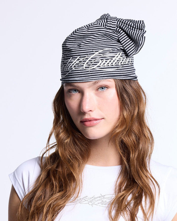 SCRIPTED STRIPES KNOT BEANIE BLACK - black striped knot beanie, front view on female model - Cold Culture