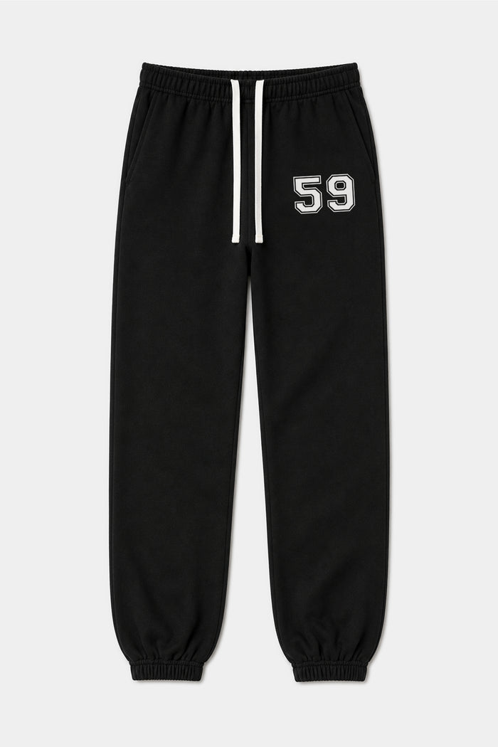The SPLITS59 Serena French Terry Oversized Sweatpant in Black/59 features an elastic waistband with a white drawstring, elastic cuffs, and the number 59 printed in white on the left thigh. This oversized sweatpant is displayed laid flat against a plain background.