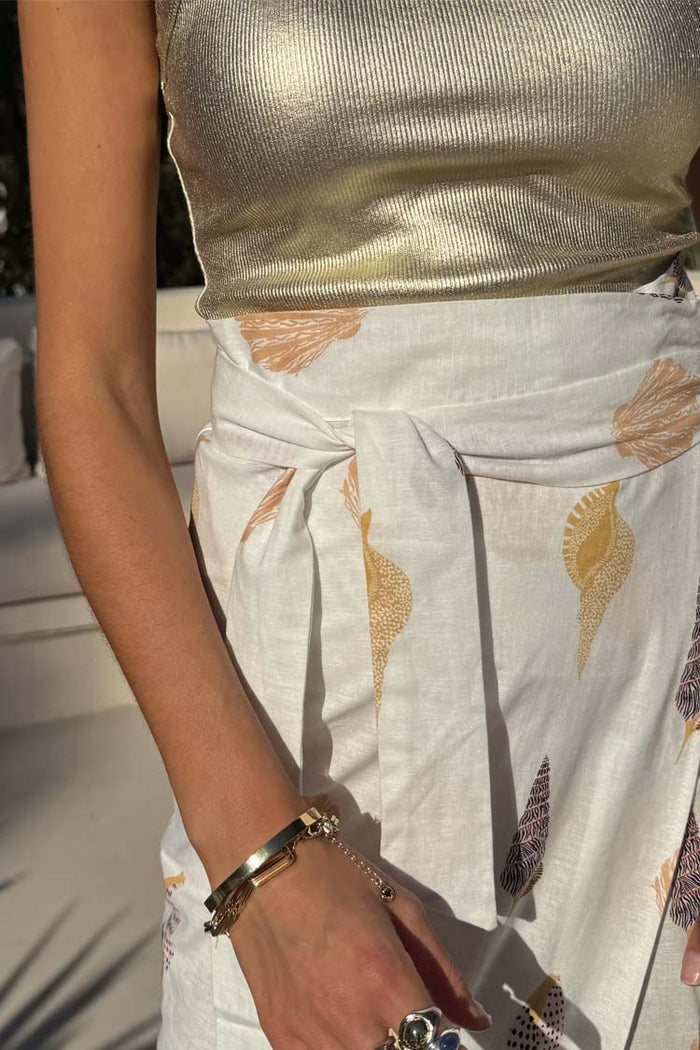 Shells Jaspre Wrap Skirt in white with an orange shell print and adjustable multi-wear tie-waist.