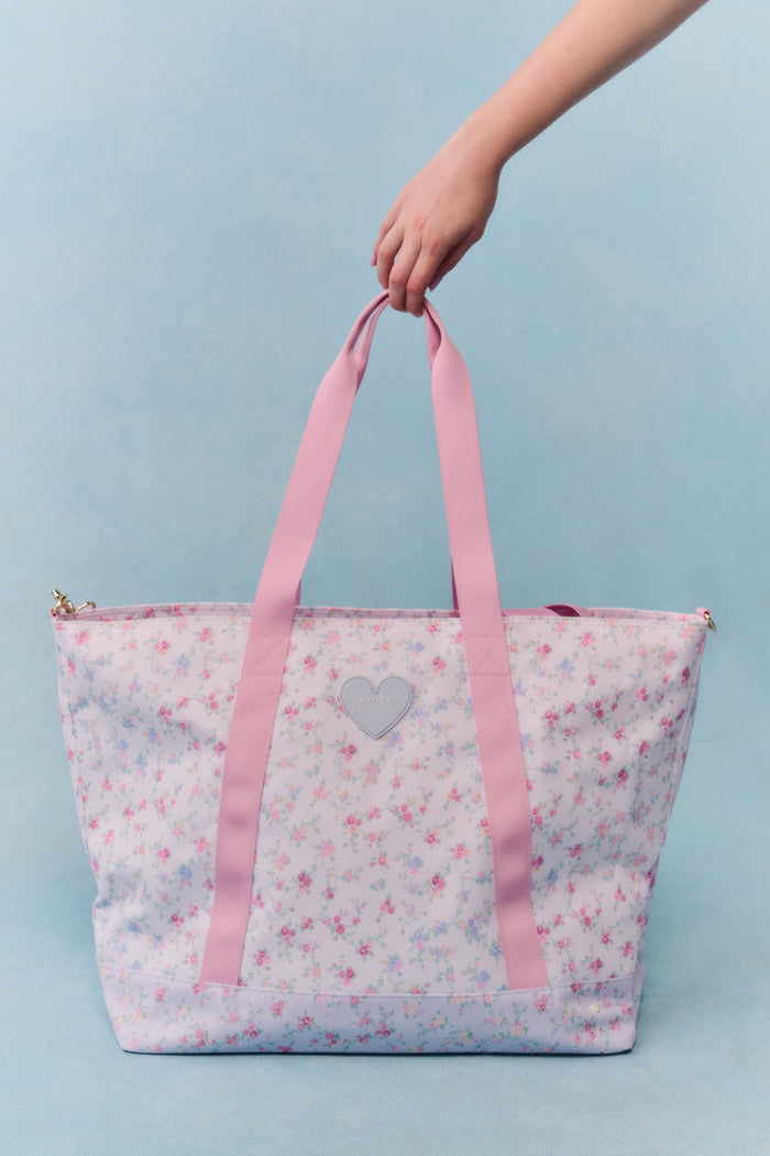 Tote bag with floral pattern and pink heart on a light blue background