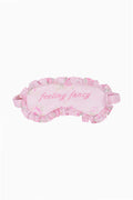 Pink sleep mask with floral pattern and 'feeling fancy' text on a white background