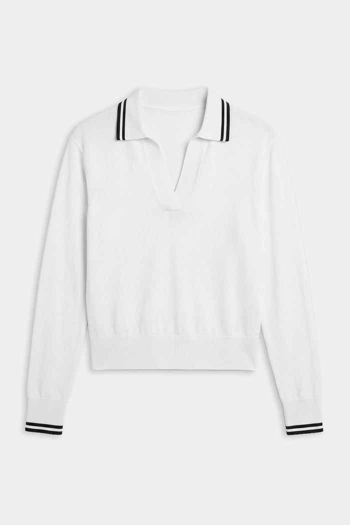 The SPLITS59 Taylor Knit Polo in White/Black is a long-sleeve sweater featuring a V-neck and black double stripes on the collar and cuffs, crafted from soft, breathable fabric and shown laid flat on a white background.