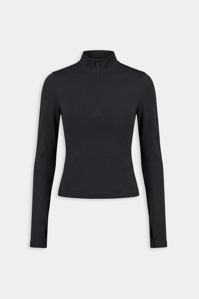 The SPLITS59 Tess Rigor Half Zip Waist Length in black is a women’s long-sleeve top with a mock neck and front half-zip, made from a soft nylon-spandex blend, shown laid flat on a white background.
