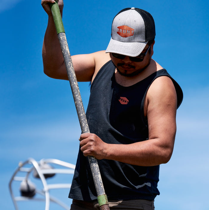 Man on jobsite wearing BRUNT comfortable work tank top in black