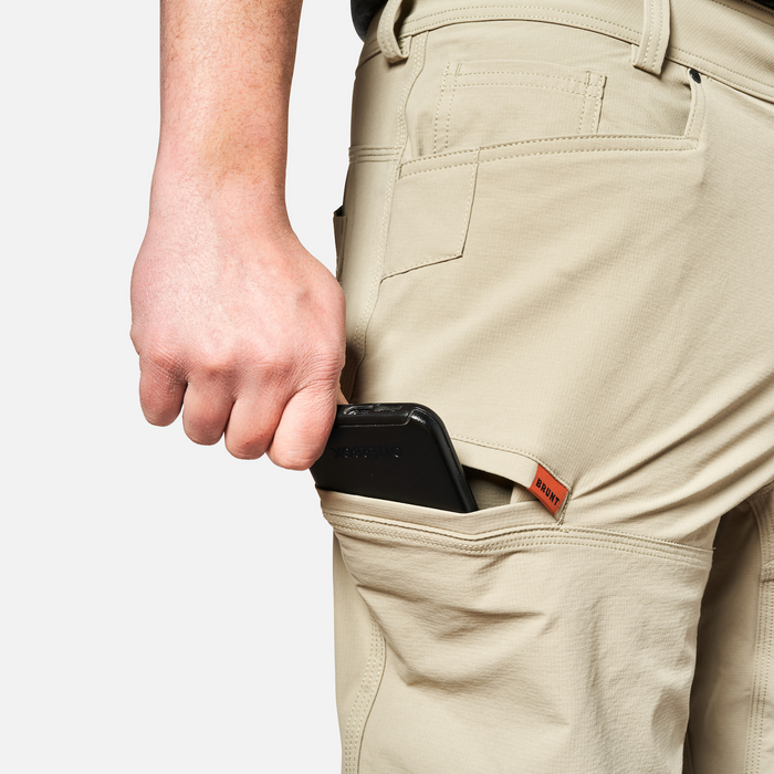 Putting phone in tech pocket of BRUNT water-resistant lightweight breathable costello work pant in khaki * 0