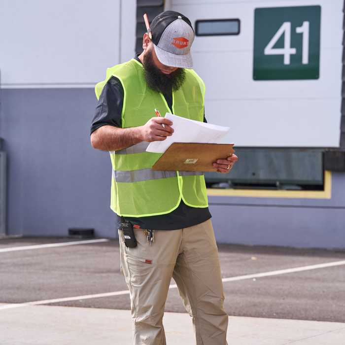 Man on jobsite wearing BRUNT water-resistant lightweight breathable costello work pant in khaki