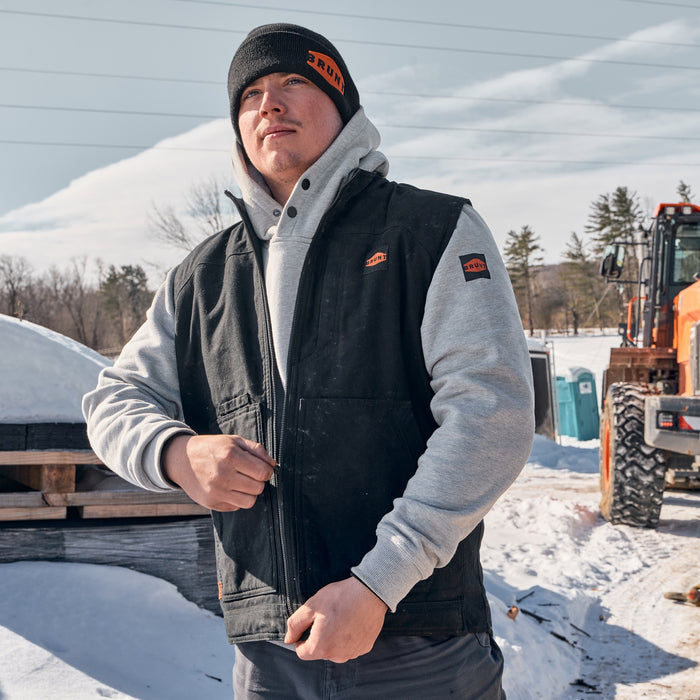 Man wearing BRUNT quilt stretch canvas work vest in black on the jobsite