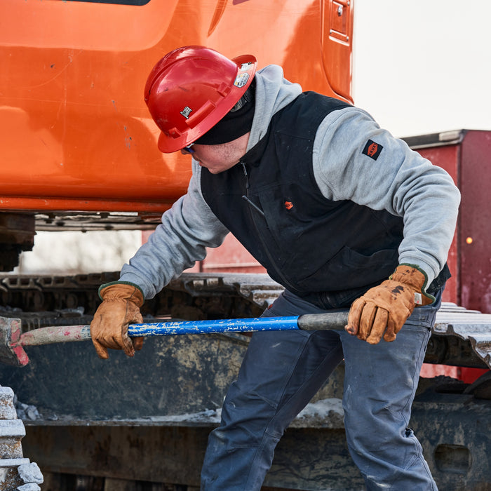 Man wearing BRUNT quilt stretch canvas work vest in black on the jobsite