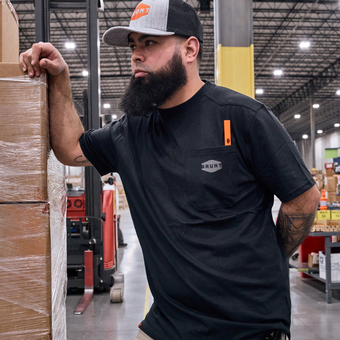 Man wearing BRUNT high quality short sleeve pocket tee in black outside on jobsite