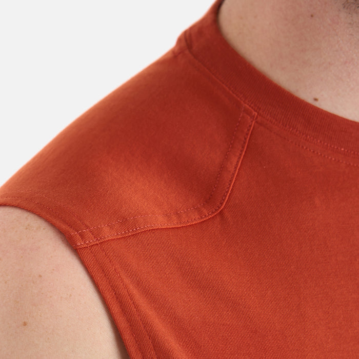 Close up of the drop shoulder of the BRUNT comfortable sleeveless pocket tee in BRUNT orange * 1