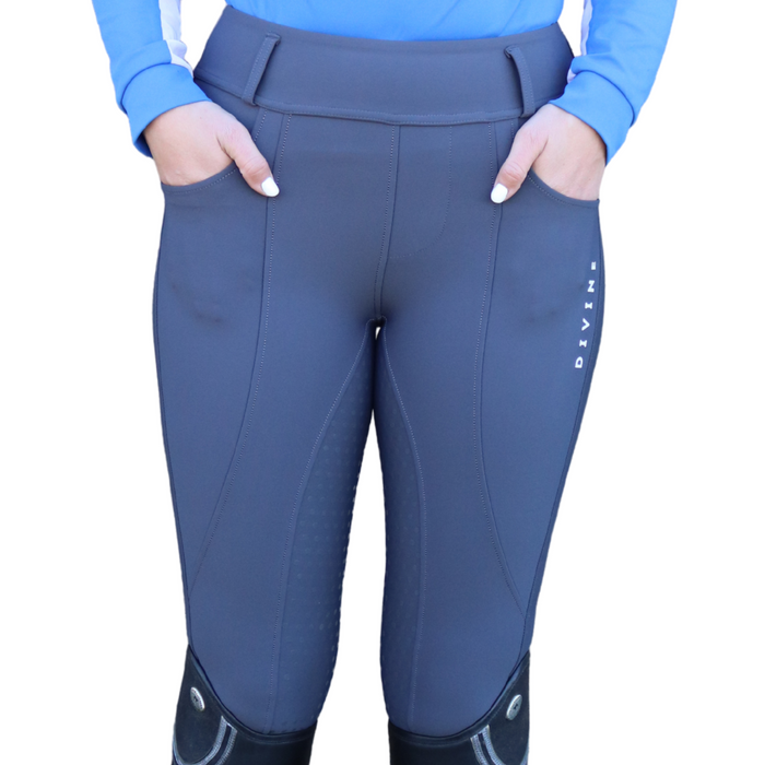 Gray riding pants with a logo on a white background
