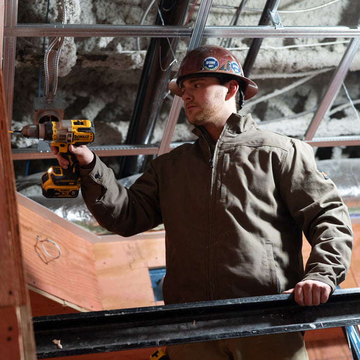 Man wearing BRUNT utility scott jacket in brown using drill on jobsite * 0