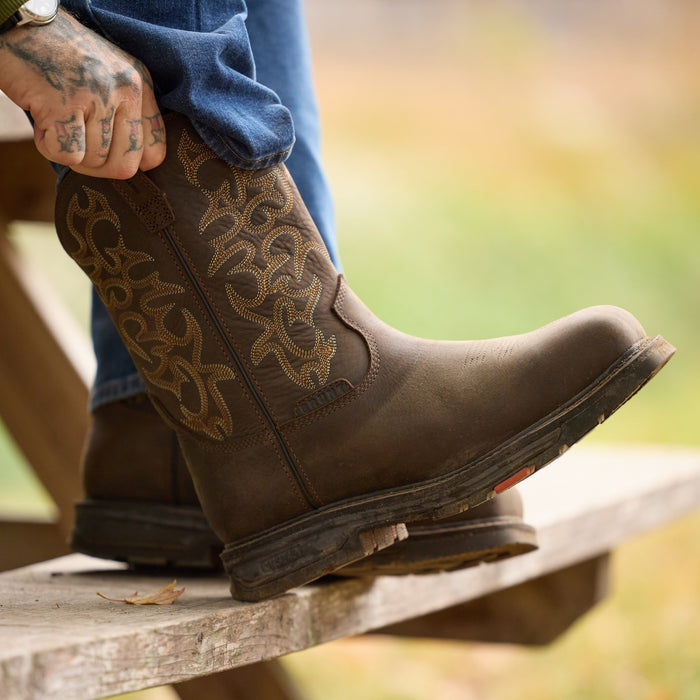 Man putting on BRUNT 10 inch welted square toe work boot in dark brown