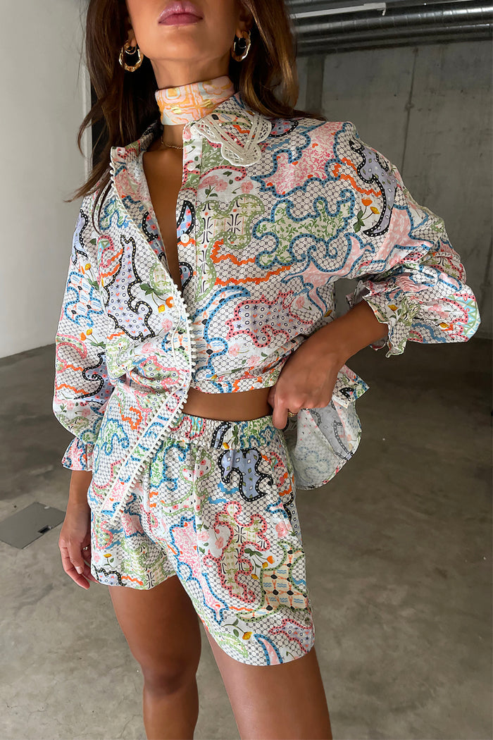 White Magnolia Elissa Shorts in a cotton linen patchwork print with an elasticated waist.