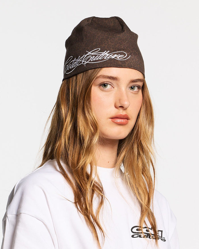 WILD SCRIPT BEANIE LEOPARD - brown leopard print beanie, on model close-up - Cold Culture #woman
