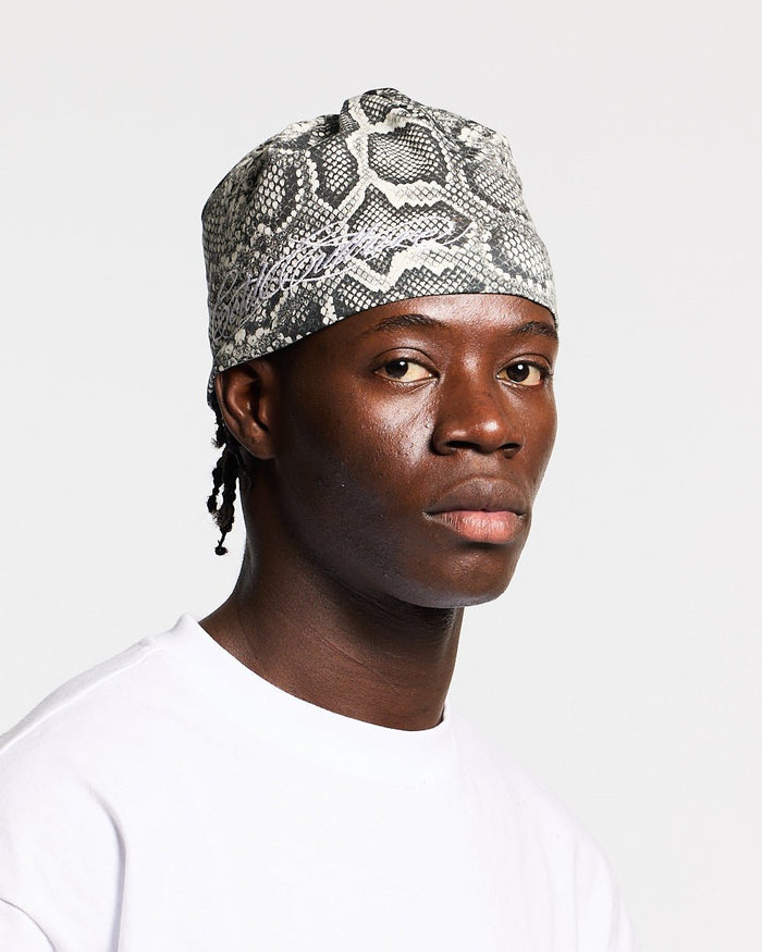 WILD SCRIPT BEANIE SNAKE - grey snake print beanie, on model close-up - Cold Culture #man