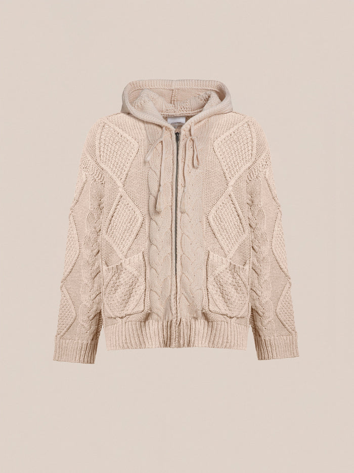 A beige, chunky knit, zip-up hoodie with a hood, featuring intricate cable knit patterns and two front pockets for comfort and warmth is the Zip Up Cable Knit Hoodie by Found.